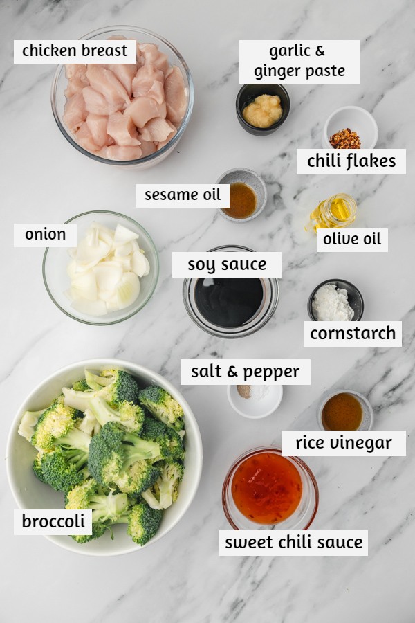 ingredients to make stir fry on a white marble surface.